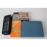 Casio fx-115 boxed calculator, Philips PR143 mobile phone, Casio CM-100 boxed calculator, and a