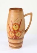 Art Deco Delwood pottery vase, with brightly coloured flowers on a light brown ground, with carrying