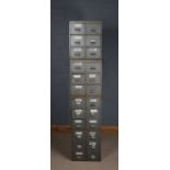 Four stackable banks of metal drawers, each bank fitted with six drawers, 194.5cm high when