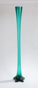 Large Art Nouveau green glass vase, of elongated form, with flared rim above a slender stem and