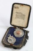 Two Silver pendants in the form of crests, both with Birmingham marks, housed in a case, gross