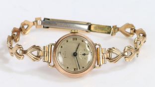 9 Carat Gold Lady's watch with a gold plated strap, the silvered dial with Roman numerals and