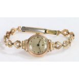 9 Carat Gold Lady's watch with a gold plated strap, the silvered dial with Roman numerals and