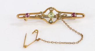 9 Carat Gold bar brooch with a peridot stone to the center and amethysts either side, gross weight