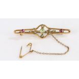 9 Carat Gold bar brooch with a peridot stone to the center and amethysts either side, gross weight