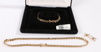 Yellow metal necklace, bracelet and earring set housed in a case