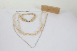 Collection of simulated pearl necklaces, one consisting of three rows of pearls together with a