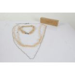 Collection of simulated pearl necklaces, one consisting of three rows of pearls together with a