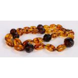 Amber bead necklace, with oval and facetted beads, 76cm long, 104.7g