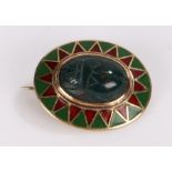 Egyptian revival brooch, the agate scarab beetle set into an oval 14 carat gold enamelled mount,