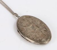 Elizabeth II silver locket, of oval form with engraved foliate and scroll decoration, on a