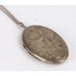 Elizabeth II silver locket, of oval form with engraved foliate and scroll decoration, on a