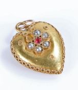 Indian Yellow metal heart shaped pendant with a ruby and pearl design to both sides