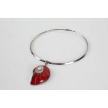 Silver necklace with a red couloured pendant shaped as a fossil