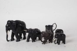 Five ebony elephants, one with trunk raised, silver plated christening mug initialled PEE (6)