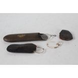 Four pairs of old spectacles, three housed in leather clad cases