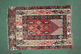 South American style rug, the red cream and black coulourings with a cross like border and a