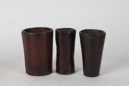 Three leather dice shakers, of tapering form (3)