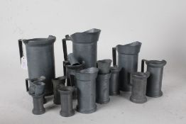 Collection of sixteen pewter measures, the largest 21.5cm high (16)