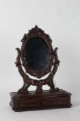 Black Forest dressing table mirror, the oval mirror with carved foliate frame on leaf carved