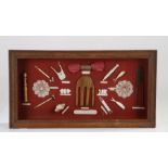 Oak glazed display case enclosing a collection of needlework accessories, to include lace bobbins