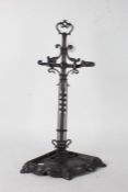 Steel corner umbrella stand, the pierced scrolled pediment above two twisted umbrella supports and a