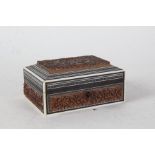 20th century Indian carved sandalwood box, carved in relief with a figure and scrolling leaves, 16cm