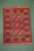 Middle eastern style rug, the red and gold coulourings with a triangular border, 126cm long 100cm