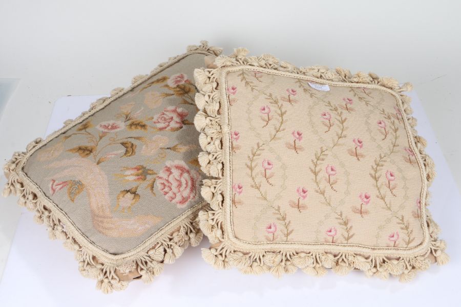 Two Chelsea textile embroidered cushions both depicting floral scenes, both have tassels surrounding