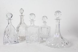 Five cut glass decanters of various styles and shapes to include a ships decanter and of baluster