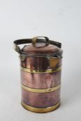 Large copper and brass jug, having lift up lid and swing handle, with brass bands to the body,