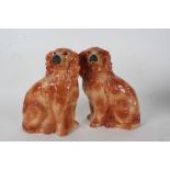 Pair of Staffordshire spaniels, each with glass eyes, 32cm high (2)