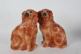 Pair of Staffordshire spaniels, each with glass eyes, 32cm high (2)