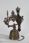 20th Century brass bell and bracket, mounted with a figure and a pair of lions above a bell with a