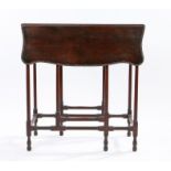George III mahogany drop leaf table, with shaped leaves with leaf and scroll edge above slender gate