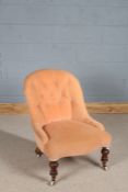 Victorian button back nursing chair, having baluster front legs and sabre back legs, the brass and