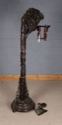 Chinese carved hardwood standard lamp, having heavily carved dragons head and column, the shade in