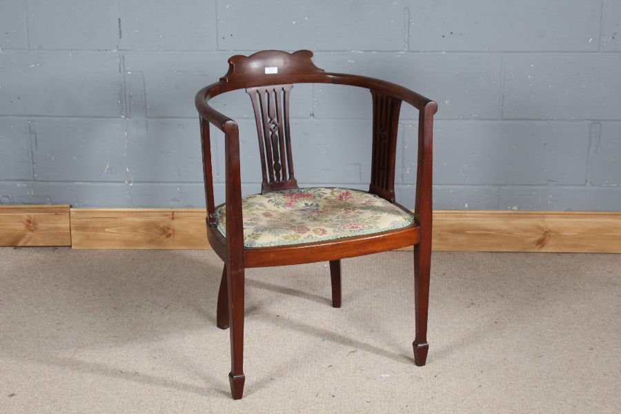 Edwardian mahogany tub chair, having shaped back rail, pierced slat backs and floral upholstery,