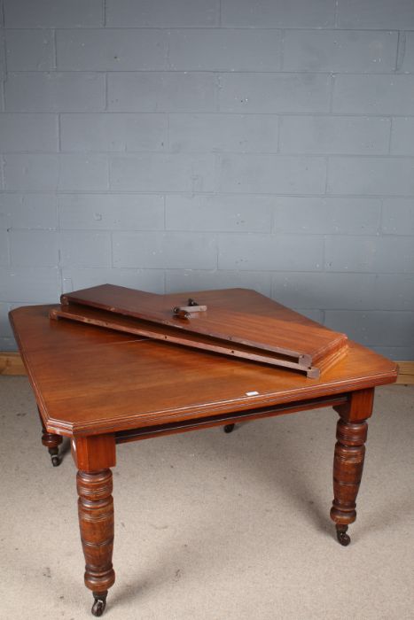 Victorian mahogany extending dining table, the rectangular top above turned legs, with two extra - Image 3 of 3