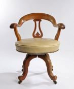 Victorian mahogany desk chair, the arched back above a shaped splat and stuff over seat above curved