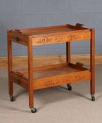 Chinese teak two tier folding trolley, carved in relief with a landscape, having lift out trays
