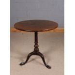 19th century mahogany occasional table, the circular tilt top above a turned column, raised on