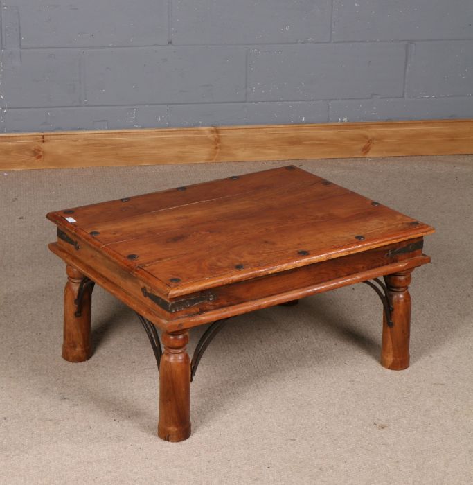 Indian hardwood coffee table, having rectangular top with metal mounts, 80cm x 60cm