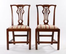 Pair of George III oak chairs, with an undulating top rail above the shaped splat and drop in seat