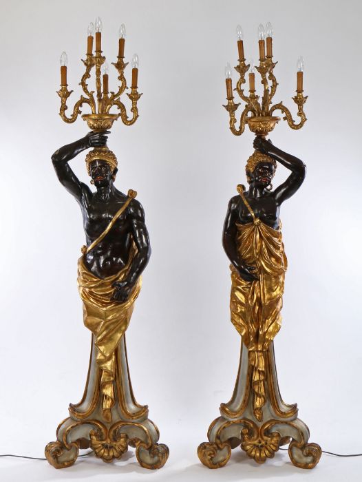 Pair of Venetian style Blackamoor candelabras, the standing male and female figures holding aloft