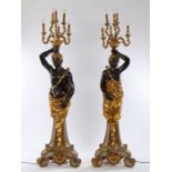 Pair of Venetian style Blackamoor candelabras, the standing male and female figures holding aloft