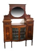 Edwardian mahogany and boxwood inlaid display cabinet, having oval mirror above a bowfront