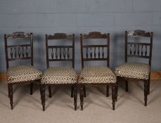 Set of four late Victorian mahogany dining chairs, each carved in relief with flowers and having