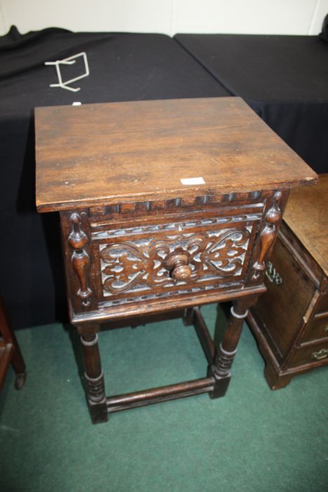 Jacobean style oak pot cupboard, with carved panelled door, raised in turned legs united by