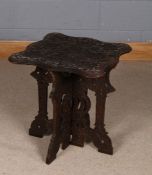 20th century carved occasional table, the shaped top carved in relief with grape and vines, raised